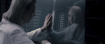 Movie still from “Chrysalis” (2007), directed by Julien Leclercq – Two people are holding hands in front of a window; Close Up shot, Over the shoulder angle