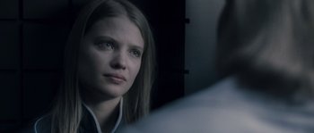 Movie still from “Chrysalis” (2007), directed by Julien Leclercq – A woman looking into a mirror while standing up; Close Up shot, Over the shoulder angle