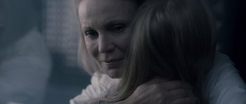 Movie still from “Chrysalis” (2007), directed by Julien Leclercq – A person with her arms wrapped around her head; Close Up shot, Over the shoulder angle