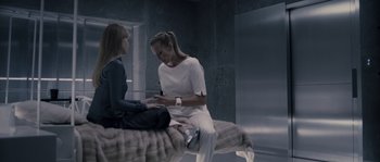 Movie still from “Chrysalis” (2007), directed by Julien Leclercq – Two women sitting on a bed talking to each other; Medium shot, Overhead angle