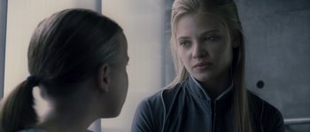 Movie still from “Chrysalis” (2007), directed by Julien Leclercq – A woman with blonde hair is looking at another woman; Close Up shot, Over the shoulder angle