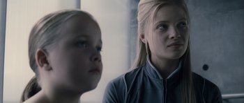 Movie still from “Chrysalis” (2007), directed by Julien Leclercq – Two young girls looking at each other in a room; Close Up shot, Over the shoulder angle