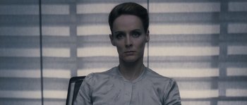 Movie still from “Chrysalis” (2007), directed by Julien Leclercq – A woman sitting in a chair in a room; Close Up shot, Low angle