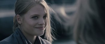 Movie still from “Chrysalis” (2007), directed by Julien Leclercq – A person with long blonde hair; Close Up shot, Over the shoulder angle