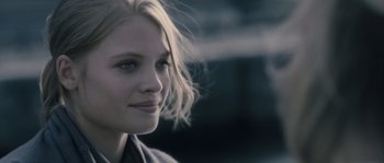 Movie still from “Chrysalis” (2007), directed by Julien Leclercq – A woman's face with a blurry background; Close Up shot, Over the shoulder angle
