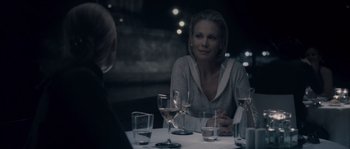 Movie still from “Chrysalis” (2007), directed by Julien Leclercq – A woman sitting at a table in front of two other women; Close Up shot, Over the shoulder angle