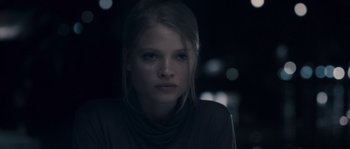 Movie still from “Chrysalis” (2007), directed by Julien Leclercq – A young woman is looking into the camera; Close Up shot, Low angle