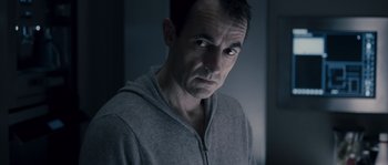 Movie still from “Chrysalis” (2007), directed by Julien Leclercq – A person wearing a hoodie; Close Up shot, Low angle