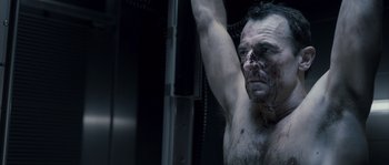 Movie still from “Chrysalis” (2007), directed by Julien Leclercq – A shirtless man with blood all over his face; Close Up shot, Low angle