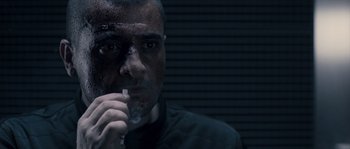 Movie still from “Chrysalis” (2007), directed by Julien Leclercq – A person holding something in his hand; Close Up shot, Over the shoulder angle