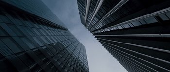 Movie still from “Chrysalis” (2007), directed by Julien Leclercq – Looking up at a skyscraper in the middle of the day; Extreme Wide shot, Low angle