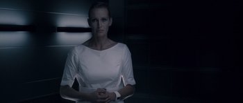 Movie still from “Chrysalis” (2007), directed by Julien Leclercq – A woman in a white dress standing in a dark room; Close Up shot, Low angle