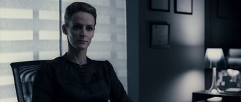 Movie still from “Chrysalis” (2007), directed by Julien Leclercq – A woman standing in a room wearing a black dress; Close Up shot, Low angle