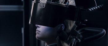 Movie still from “Chrysalis” (2007), directed by Julien Leclercq – A woman wearing a helmet and ear buds; Extreme Close Up shot, Over the shoulder angle