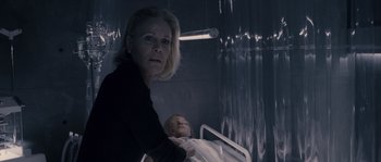 Movie still from “Chrysalis” (2007), directed by Julien Leclercq – A woman standing next to an infant in a hospital bed; Close Up shot, Over the shoulder angle