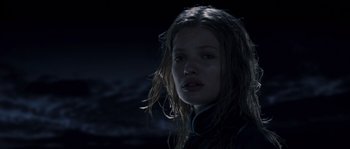 Movie still from “Chrysalis” (2007), directed by Julien Leclercq – A woman with long hair is standing in the dark; Close Up shot, Low angle
