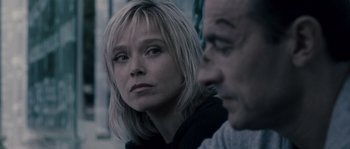 Movie still from “Chrysalis” (2007), directed by Julien Leclercq – A woman and a man are sitting next to each other; Close Up shot, Over the shoulder angle