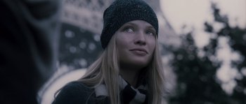Movie still from “Chrysalis” (2007), directed by Julien Leclercq – A woman wearing a hat and scarf looking up; Close Up shot, Low angle