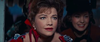 Movie still from “Cimarron” (1960), directed by Charles Walters – A person wearing a dress; Close Up shot, Over the shoulder angle