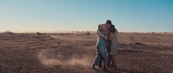 Movie still from “Cimarron” (1960), directed by Charles Walters – A group of people hugging in the middle of a field; Wide shot, Low angle