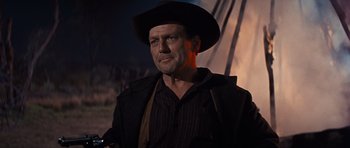 Movie still from “Cimarron” (1960), directed by Charles Walters – A person wearing a cowboy hat; Medium shot, Low angle
