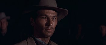 Movie still from “Cimarron” (1960), directed by Charles Walters – A person wearing a hat; Close Up shot, Low angle