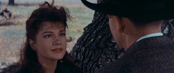 Movie still from “Cimarron” (1960), directed by Charles Walters – A man and a woman are talking to each other; Close Up shot, Over the shoulder angle