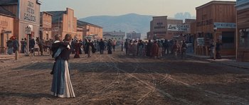 Movie still from “Cimarron” (1960), directed by Charles Walters – A group of people standing on a dirt field; Extreme Wide shot, High angle