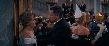 Movie still from “Cimarron” (1960), directed by Charles Walters – A group of people sitting at tables in a room; Medium shot, Over the shoulder angle