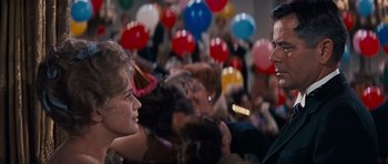 Movie still from “Cimarron” (1960), directed by Charles Walters – A group of people sitting in a room with balloons; Close Up shot, Over the shoulder angle