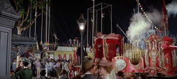 Movie still from “Circus World” (1964), directed by Henry Hathaway – A crowd of people standing around a circus tent at night; Extreme Wide shot, High angle