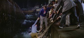Movie still from “Circus World” (1964), directed by Henry Hathaway – A group of people standing on top of a bridge; Wide shot, High angle