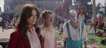 Movie still from “Circus World” (1964), directed by Henry Hathaway – A group of people standing next to each other in a field; Medium shot, Low angle