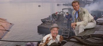 Movie still from “Circus World” (1964), directed by Henry Hathaway – A group of men standing on top of a boat; Medium shot, High angle