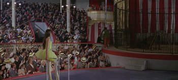 Movie still from “Circus World” (1964), directed by Henry Hathaway – A crowd of people watching a performance in an arena; Wide shot, High angle