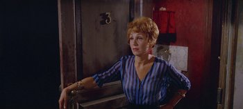 Movie still from “Circus World” (1964), directed by Henry Hathaway – An older woman in a blue and black striped shirt; Medium shot, High angle
