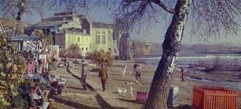 Movie still from “Circus World” (1964), directed by Henry Hathaway – A group of people standing on top of a sandy beach; Extreme Wide shot, High angle