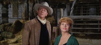 Movie still from “Circus World” (1964), directed by Henry Hathaway – A man and a woman standing next to each other; Medium shot, Low angle