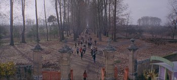 Movie still from “Circus World” (1964), directed by Henry Hathaway – A group of people walking down a dirt road; Extreme Wide shot, High angle