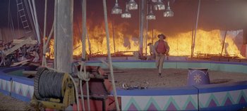 Movie still from “Circus World” (1964), directed by Henry Hathaway – A man in a cowboy hat walking through a circus; Wide shot, High angle