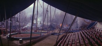 Movie still from “Circus World” (1964), directed by Henry Hathaway – An arena with a lot of fire in the background; Extreme Wide shot, High angle