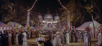 Movie still from “Circus World” (1964), directed by Henry Hathaway – A crowd of people walking on a street at night; Extreme Wide shot, High angle