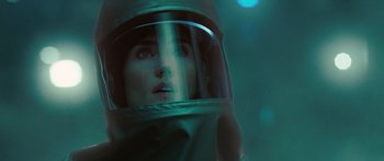 Movie still from “The Day the Earth Stood Still” (2008), directed by Scott Derrickson – A woman wearing a space helmet looking into the distance; Close Up shot, Over the shoulder angle