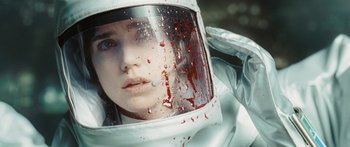 Movie still from “The Day the Earth Stood Still” (2008), directed by Scott Derrickson – A woman in a spacesuit with blood on her face; Close Up shot, Overhead angle