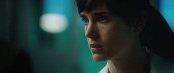 Movie still from “The Day the Earth Stood Still” (2008), directed by Scott Derrickson – A woman's face in a dark room; Close Up shot, Over the shoulder angle