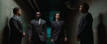 Movie still from “The Day the Earth Stood Still” (2008), directed by Scott Derrickson – A couple of men in business suits walking down a hallway; Medium shot, Low angle