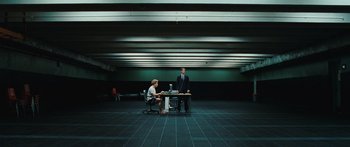 Movie still from “The Day the Earth Stood Still” (2008), directed by Scott Derrickson – A man and a woman sitting at a table in an empty room; Wide shot, Low angle
