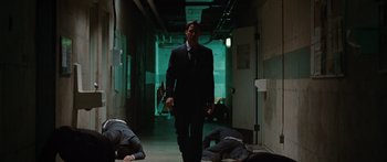 Movie still from “The Day the Earth Stood Still” (2008), directed by Scott Derrickson – A man in a suit walking down a hallway; Wide shot, Low angle