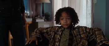 Movie still from “The Day the Earth Stood Still” (2008), directed by Scott Derrickson – A young boy sitting in a chair in front of a lamp; Close Up shot, High angle