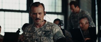 Movie still from “The Day the Earth Stood Still” (2008), directed by Scott Derrickson – A man in a military uniform with a headset on; Close Up shot, Over the shoulder angle